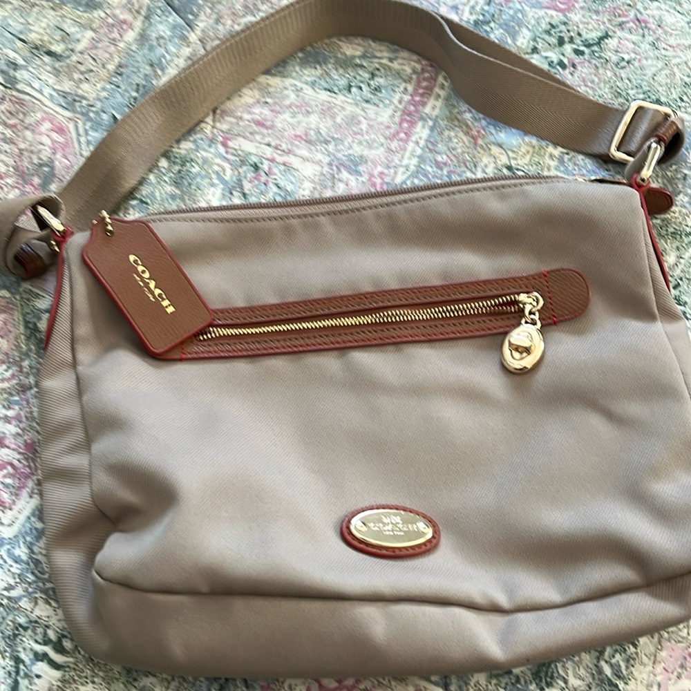 Tan and orange in the inside. Zipper pocket inside along with 2 open pockets